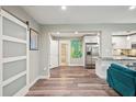 Open-concept living area with modern floors seamlessly connecting to the kitchen at 120 W Sligh Ave, Tampa, FL 33604