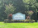 Entrance to Belle Chase community with attractive landscaping and flowering crepe myrtle trees at 1247 Gentilly Ln, Wesley Chapel, FL 33544