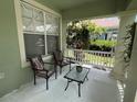 Inviting covered porch with comfortable seating, perfect for relaxing outdoors at 1247 Gentilly Ln, Wesley Chapel, FL 33544
