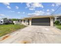 Exterior daytime view of the home and driveway with vehicle at 13727 Gene Rossi Ave, Hudson, FL 34667