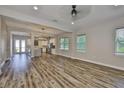 Spacious living room with hardwood floors, large windows, and an open layout to the kitchen at 1410 E Curtis St # 2, Tampa, FL 33603