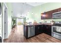Open-concept kitchen with stainless steel appliances and eat-in dining at 3002 W Cleveland St # B9, Tampa, FL 33609