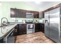 Well-equipped kitchen with stainless steel appliances and dark cabinets at 3002 W Cleveland St # B9, Tampa, FL 33609
