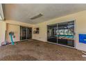 Covered patio with sliding glass doors leading to the screened-in pool area at 3150 San Jose St, Clearwater, FL 33759