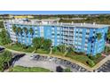 Five-story condo building in an urban area, with blue accents, palm trees, and private balconies at 3315 58Th S Ave # 421, St Petersburg, FL 33712