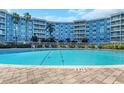 Inviting pool with brick border with lounge chairs nearby at the condo complex at 3315 58Th S Ave # 421, St Petersburg, FL 33712
