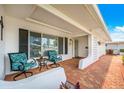 Inviting covered front porch with comfortable seating area showcasing the lovely facade at 4076 Mainlands N Blvd, Pinellas Park, FL 33782
