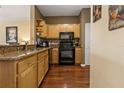 Charming kitchen features granite countertops, wooden cabinets, and modern black appliances at 4207 S Dale Mabry Hwy # 8304, Tampa, FL 33611