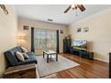 Cozy living room features a comfortable couch, hardwood floors, a ceiling fan, and a view from the window at 4207 S Dale Mabry Hwy # 8304, Tampa, FL 33611