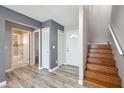 Welcoming entryway with hardwood floors, staircase, and access to adjacent bathroom and bedrooms at 428 Klosterman W Rd, Palm Harbor, FL 34683
