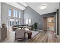 Open living room with large windows, vaulted ceiling, and modern furnishings at 428 Klosterman W Rd, Palm Harbor, FL 34683