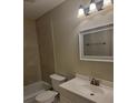 Clean bathroom featuring a vanity with storage, a mirror, and a tiled shower/tub combo at 474 Hinton St, Port Charlotte, FL 33954