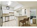 Well-lit kitchen features stainless steel appliances, speckled granite countertops, and breakfast bar at 504 S Armenia Ave # 1329B, Tampa, FL 33609