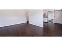 Open-concept living space featuring hardwood floors, freshly painted white walls and barn door to hall at 5221 4Th N Ave, St Petersburg, FL 33710