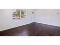 This inviting living room offers hardwood floors, freshly painted white walls and a bright and welcoming atmosphere at 5221 4Th N Ave, St Petersburg, FL 33710