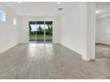 Open-concept living room with tile floors and a view to the backyard at 6019 Shorebird Br, Land O Lakes, FL 34638