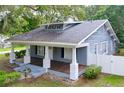 Attractive single-story home boasts a classic design with a spacious covered front porch and neat landscaping at 606 N Merrin St, Plant City, FL 33563