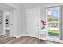 Bright entryway featuring wood floors, a window with decorative etching, and a decorative flower arrangement at 6511 10Th N St, St Petersburg, FL 33702