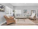 Bright and airy living room with neutral decor, wood-look floors, and comfortable seating at 6511 10Th N St, St Petersburg, FL 33702