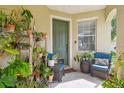 Cozy front porch with potted plants and comfortable seating, perfect for relaxing outdoors at 9329 Wellstone Dr, Land O Lakes, FL 34638