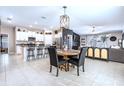 Bright open floor plan features a modern kitchen with stainless steel appliances, adjacent to dining and living areas at 9839 Lemon Drop Loop, Sun City Center, FL 33573