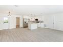 Spacious open-concept design featuring hardwood floors, connecting living and a modern, bright kitchen at 1008 Shangri La Dr, Seffner, FL 33584