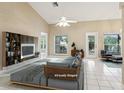 Spacious living room featuring tile floors, a fan, and a decorative stone wall at 10304 Rainbow Oaks Dr, Hudson, FL 34667