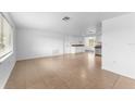 Spacious living room with tile flooring, light walls, and plenty of natural light at 1051 Pert Ln, Holiday, FL 34691