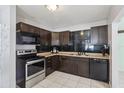 Well-appointed kitchen with dark cabinetry, stainless steel appliances, and tile backsplash at 109 Emerald Ln, Largo, FL 33771