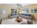 Bright and airy living room with neutral tones, comfortable seating, and large windows at 109 Emerald Ln, Largo, FL 33771