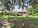 Ranch style home with stone facade and well maintained lawn at 11307 Sandpine Rd, Riverview, FL 33569