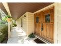 Inviting front porch with decorative wooden door and hanging plants for an inviting entrance to the residence at 11307 Sandpine Rd, Riverview, FL 33569
