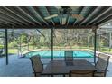 Screened-in patio featuring a pool with an attached spa, dining area, and verdant landscaping at 11307 Sandpine Rd, Riverview, FL 33569