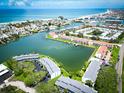 A scenic aerial view of waterfront condos along a tranquil canal near the ocean and beach at 12132 Capri S Cir, Treasure Island, FL 33706