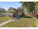 Inviting single-Gathering home featuring a landscaped yard, quaint porch, and a cozy, welcoming facade at 1225 22Nd S Ave, St Petersburg, FL 33705