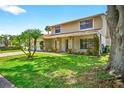 Attractive home featuring a well-maintained lawn, lovely landscaping, and an inviting entrance at 15925 Marshfield Dr, Tampa, FL 33624