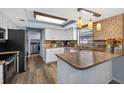 Bright kitchen featuring white cabinets, stainless steel appliances, and stylish countertops at 15925 Marshfield Dr, Tampa, FL 33624