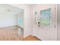Bright entryway featuring a decorative glass door and gleaming wood floors at 2063 De Carlo Ave, Spring Hill, FL 34608