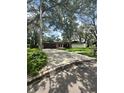 Traditional home boasts a spacious driveway and beautiful, mature trees at 2102 Doefield Ct, Valrico, FL 33596