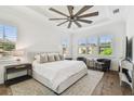 Bright bedroom featuring a tray ceiling, hardwood floors, and plantation shutters at 2604 W Jetton Ave, Tampa, FL 33629