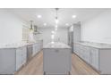 Bright kitchen features grey cabinets, stainless steel appliances, marble countertops, and a large center island at 3505 Medulla Rd, Plant City, FL 33566