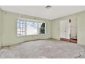 Bright living room with a large bay window and an open doorway, lots of natural light at 4173 85Th N St, St Petersburg, FL 33709