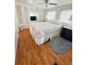 Relaxing bedroom featuring wood laminate floors, built in storage, and natural light, creating a peaceful retreat at 4851 W Gandy Blvd # B7L36, Tampa, FL 33611