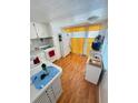Functional kitchen with laminate flooring, bright yellow curtains, and ample counter space, ready for your personal touch at 4851 W Gandy Blvd # B7L36, Tampa, FL 33611