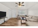 Bright living room featuring hardwood floors, neutral walls, and a comfortable sectional sofa at 4945 91St N Ave # 30, Pinellas Park, FL 33782
