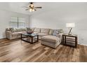 Spacious living room with hardwood floors and a large sectional sofa at 4945 91St N Ave # 30, Pinellas Park, FL 33782