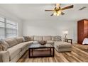 Inviting living room featuring wood-look floors and a plush sectional sofa at 4945 91St N Ave # 30, Pinellas Park, FL 33782