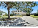Beautiful home with mature tree, well-manicured lawn, and a two-car garage at 5205 Brighton Shore Dr, Apollo Beach, FL 33572