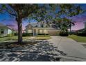Beautiful home with mature tree, well-manicured lawn, and a two-car garage at 5205 Brighton Shore Dr, Apollo Beach, FL 33572