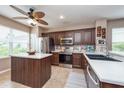 Well-equipped kitchen featuring an island, modern appliances, and ample cabinet space at 5410 River Sound Ter, Bradenton, FL 34208